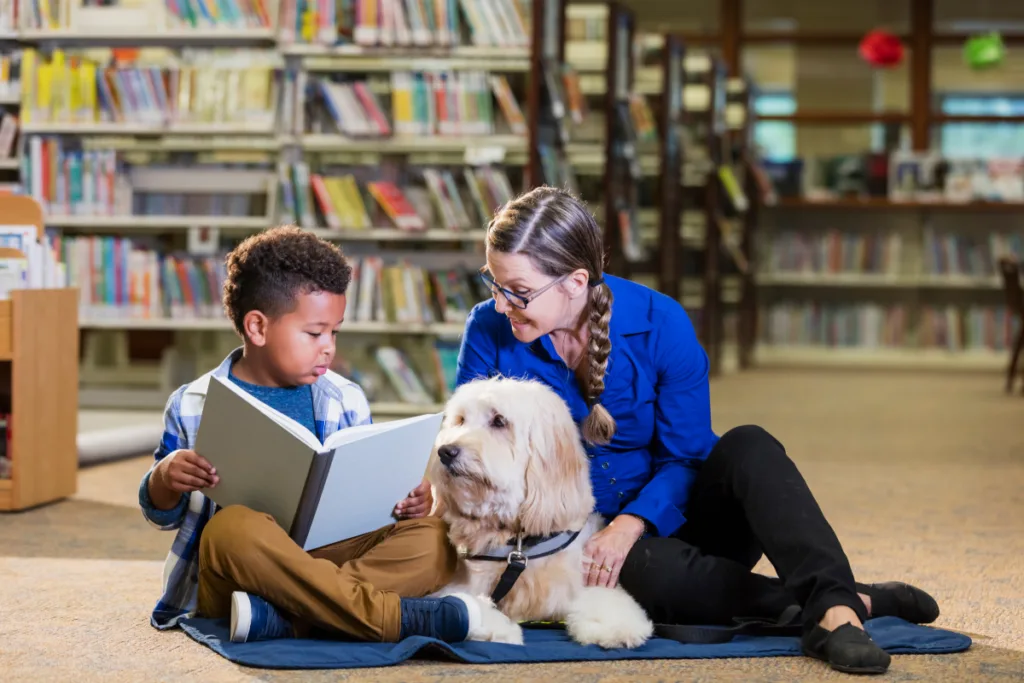 therapy dog with kid reading